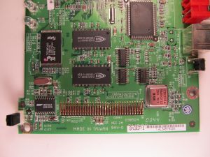 SerComm label + text (obscured) on the Linksys WMA11B
